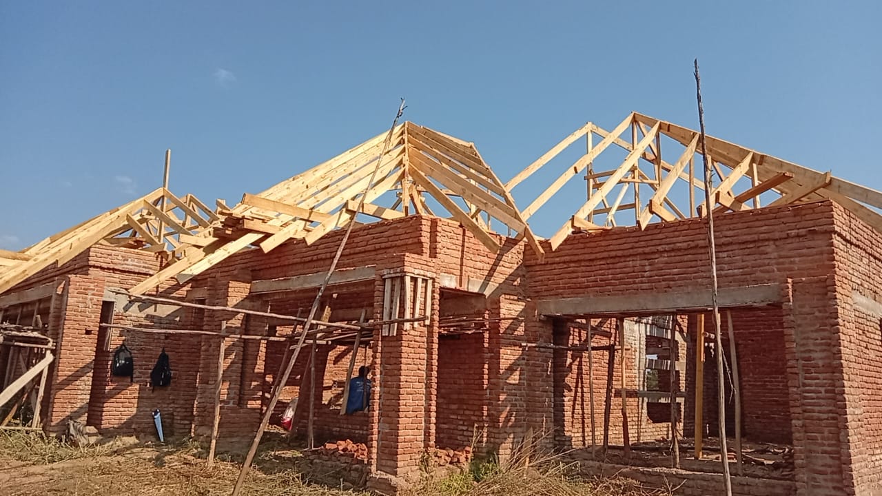 Timber roof trusses above brick walls