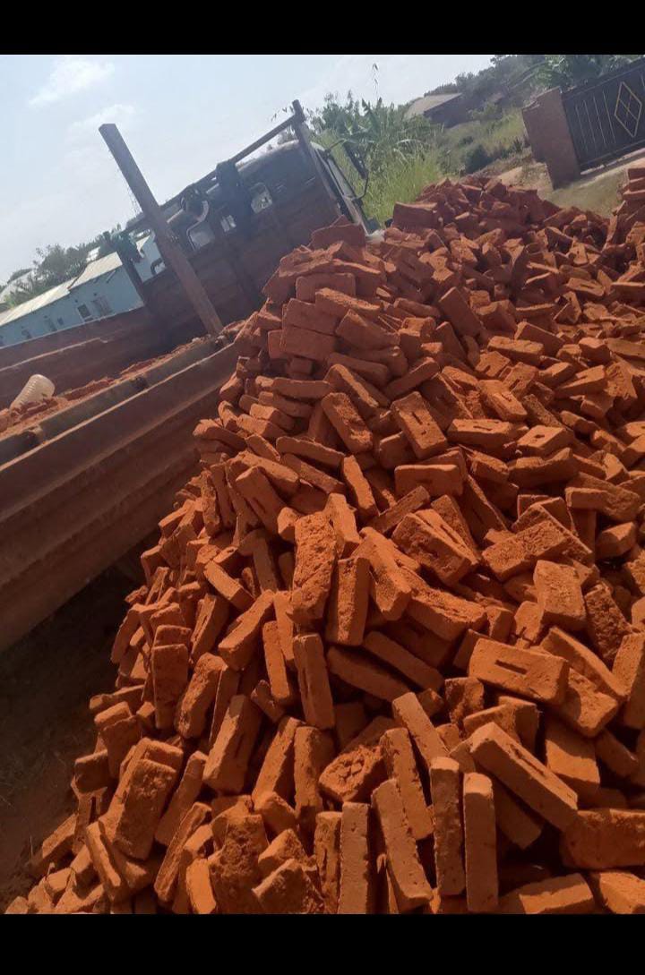 Red bricks unloaded beside a truck