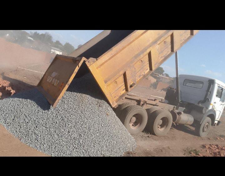 Tipper truck unloading aggregate