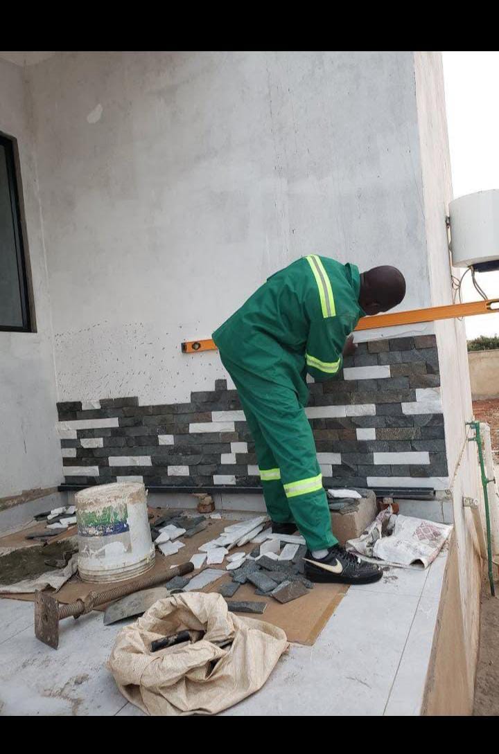 On-site worker installing exterior wall finishes